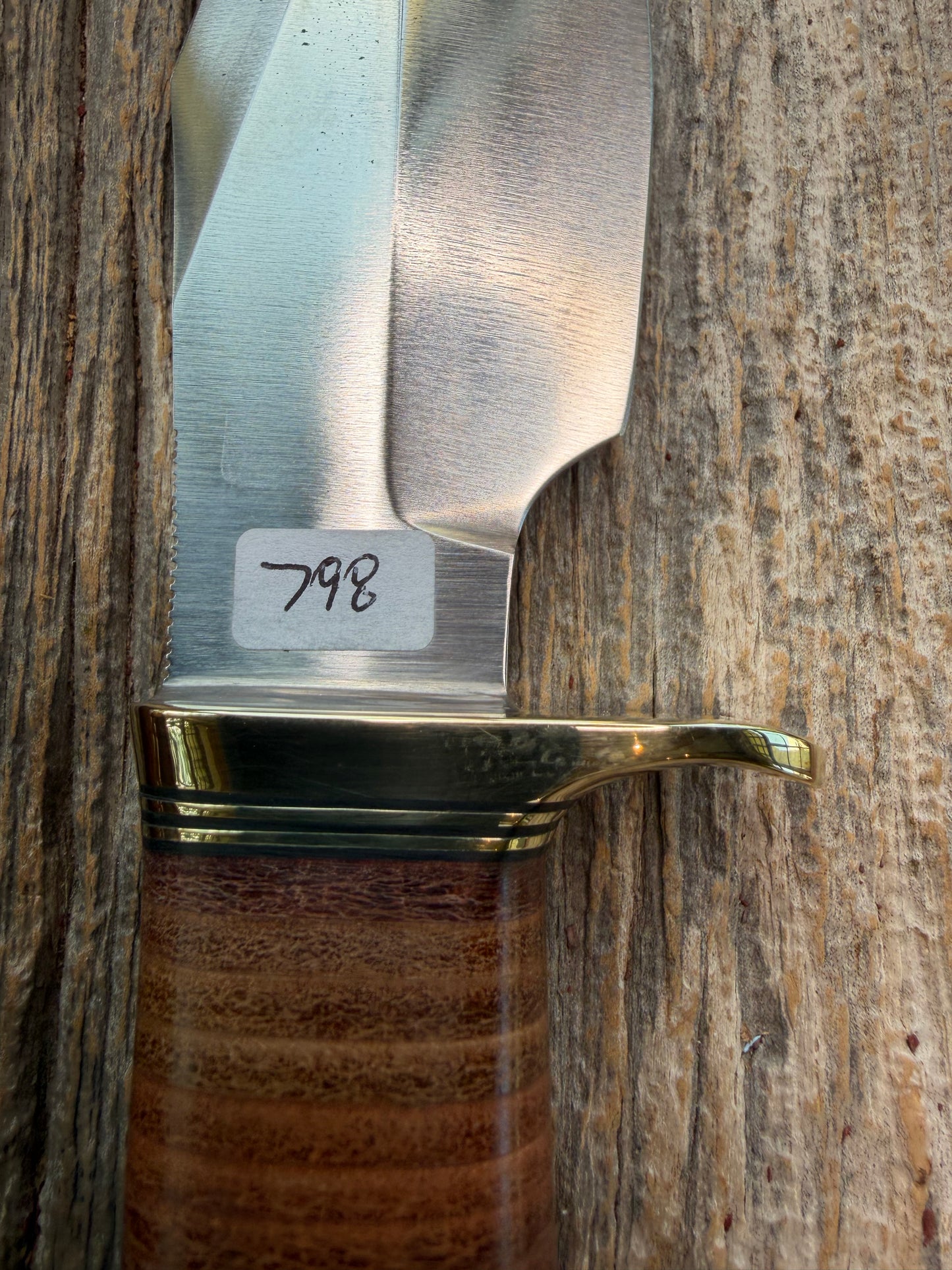 New Randall Model 19-5 Bushmaster with a Leather handle. Carbon blade, Brass single hilt. Brown leather sheath.