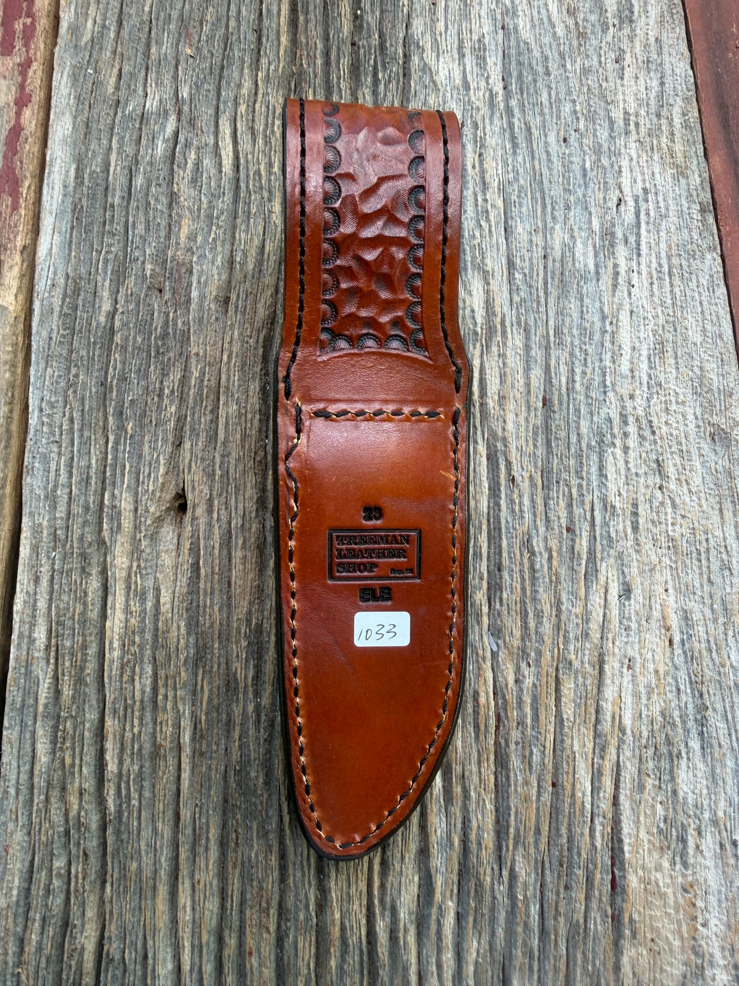 New Randall Model 23 Sheath in Exotic thick and textured Rust colored Elephant hide on brown leather from Treeman with a black Canteen snap. Hand tooled belt loop. Killer sheath.