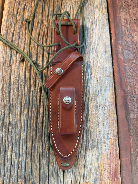 Mint Randall by Gutcher Knife Sheath for a Model Buxton Fighter. Randall snaps, double stitched, pouch with stone, lanyards straps as well.