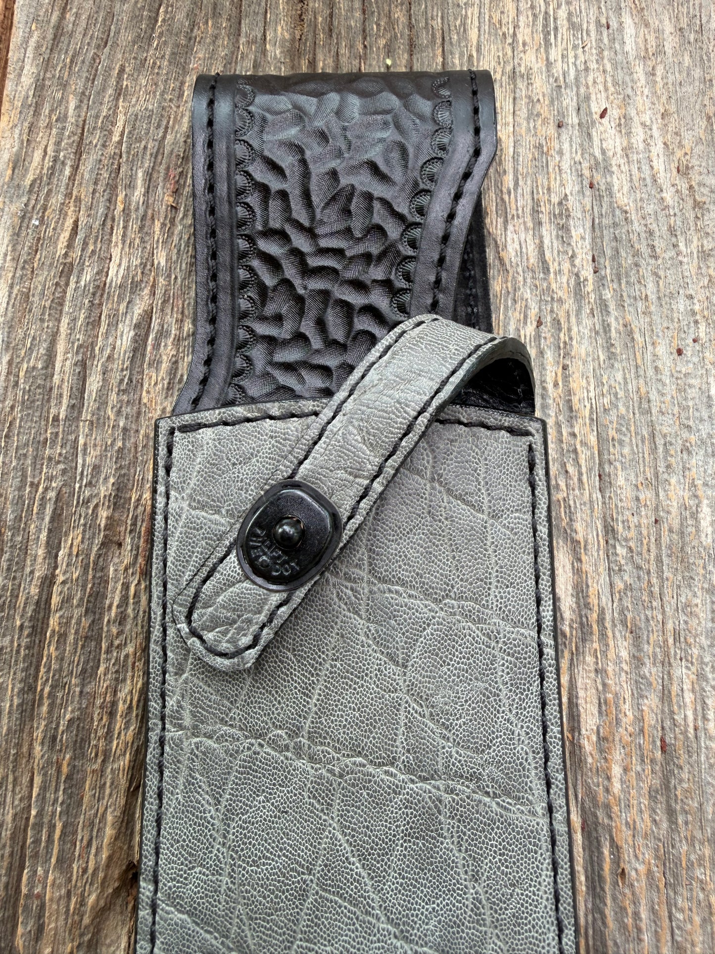 New Randall Model 12-11 Large Sasquatch Sheath in Exotic thick and textured Grey Elephant Hide on black leather from Treeman with a black Canteen snap. Hand tooled belt loop. Killer sheath.