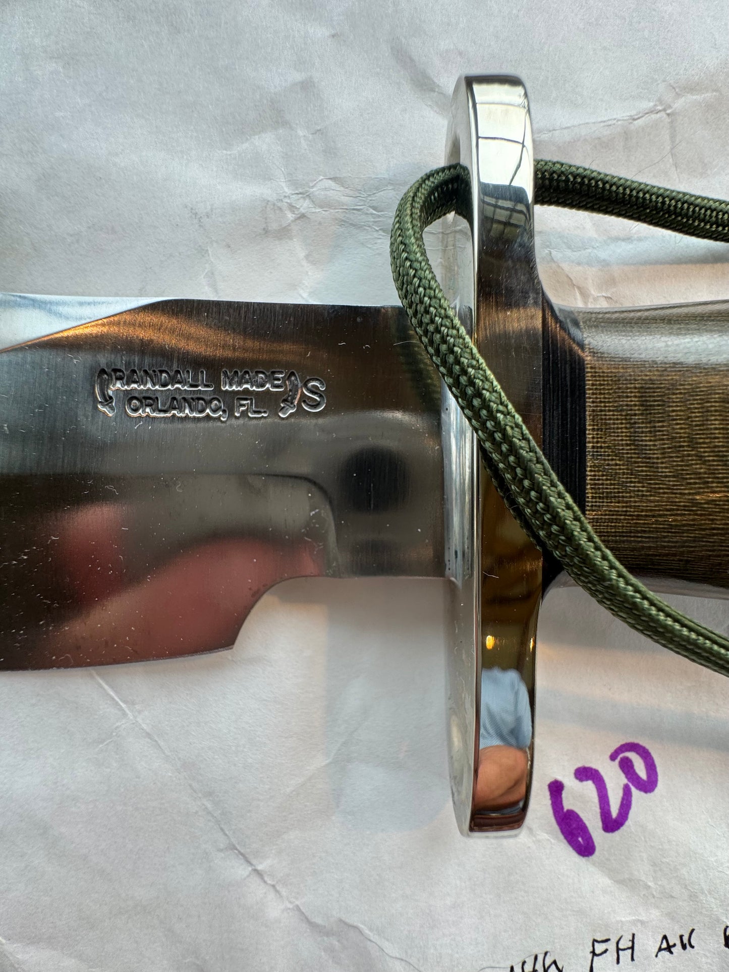 New in Paper Randall Model 19-5 Bushmaster with an Green Micarta handle. SS blade, Nickel silver single hilt. Lanyard. Brown leather sheath.