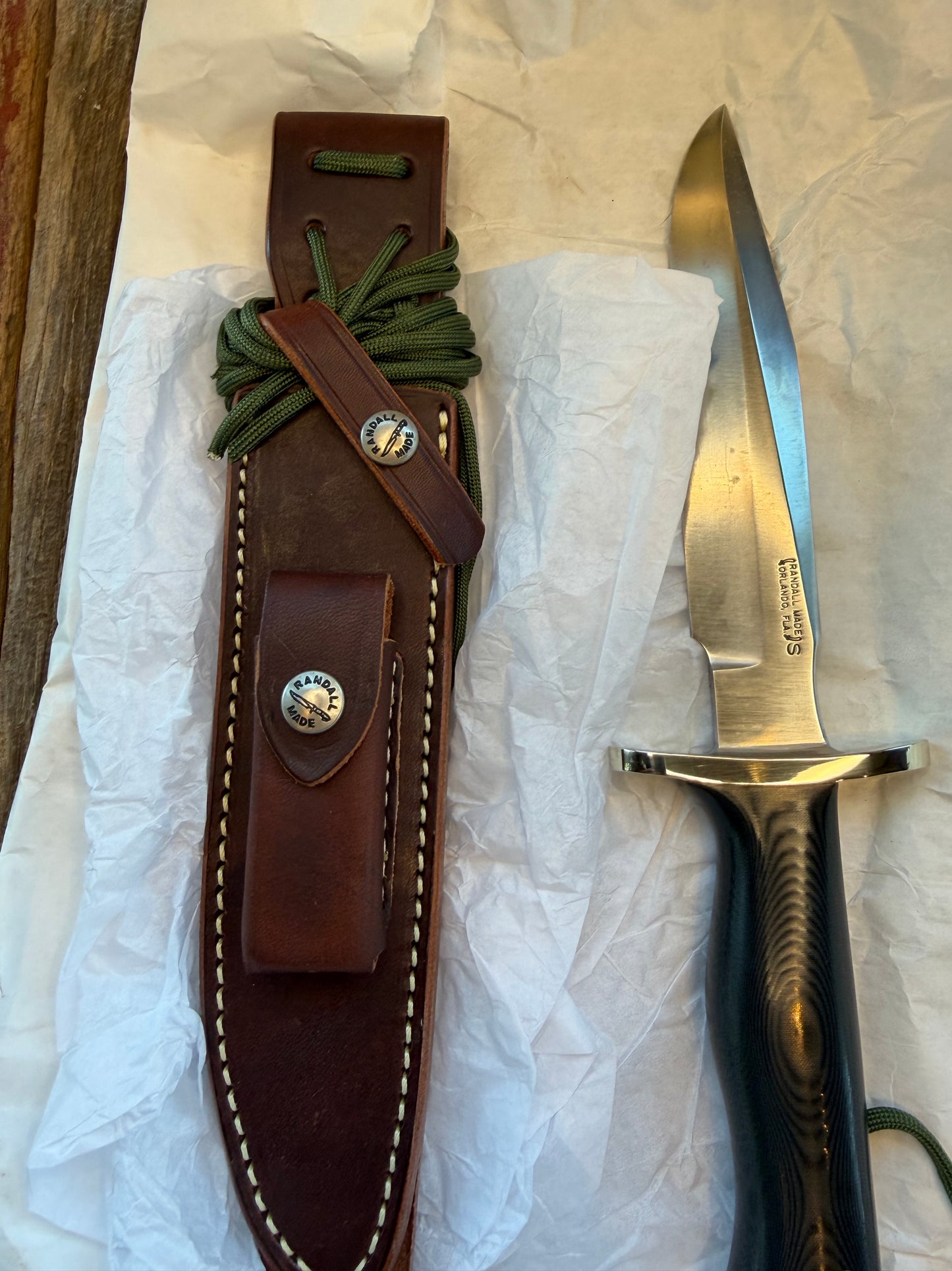New in Paper Randall Model 16 SP#1 Special fighter with a Black Micarta handle. SS blade, Nickel silver Forward Curved hilt. Lanyard. Brown leather sheath.