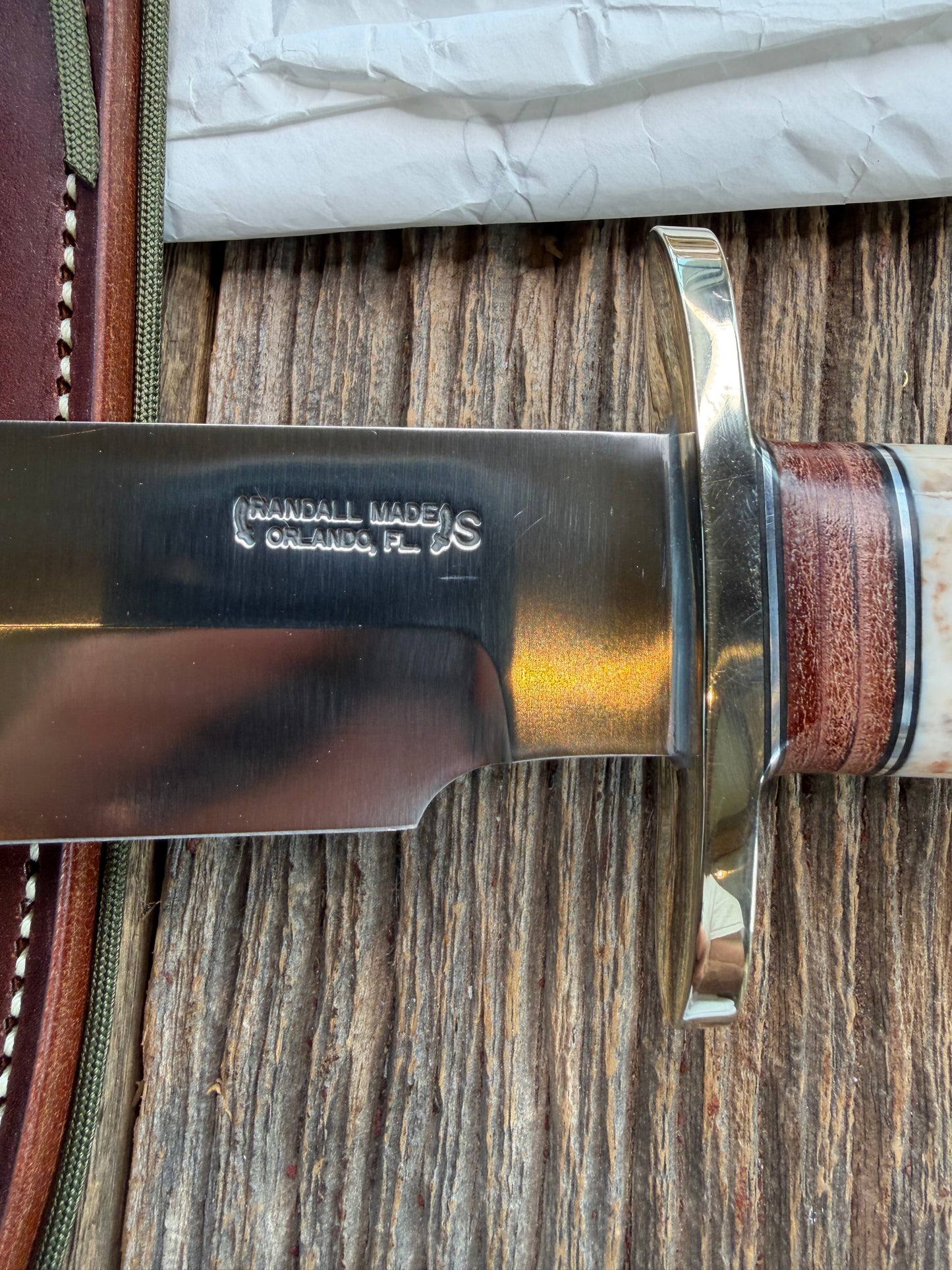 New in Paper Randall Model 12-9 Fossil Walrus Ivory and 25 style stacked Leather grip. Double Nickel Silver hilt and nickel butt cap.