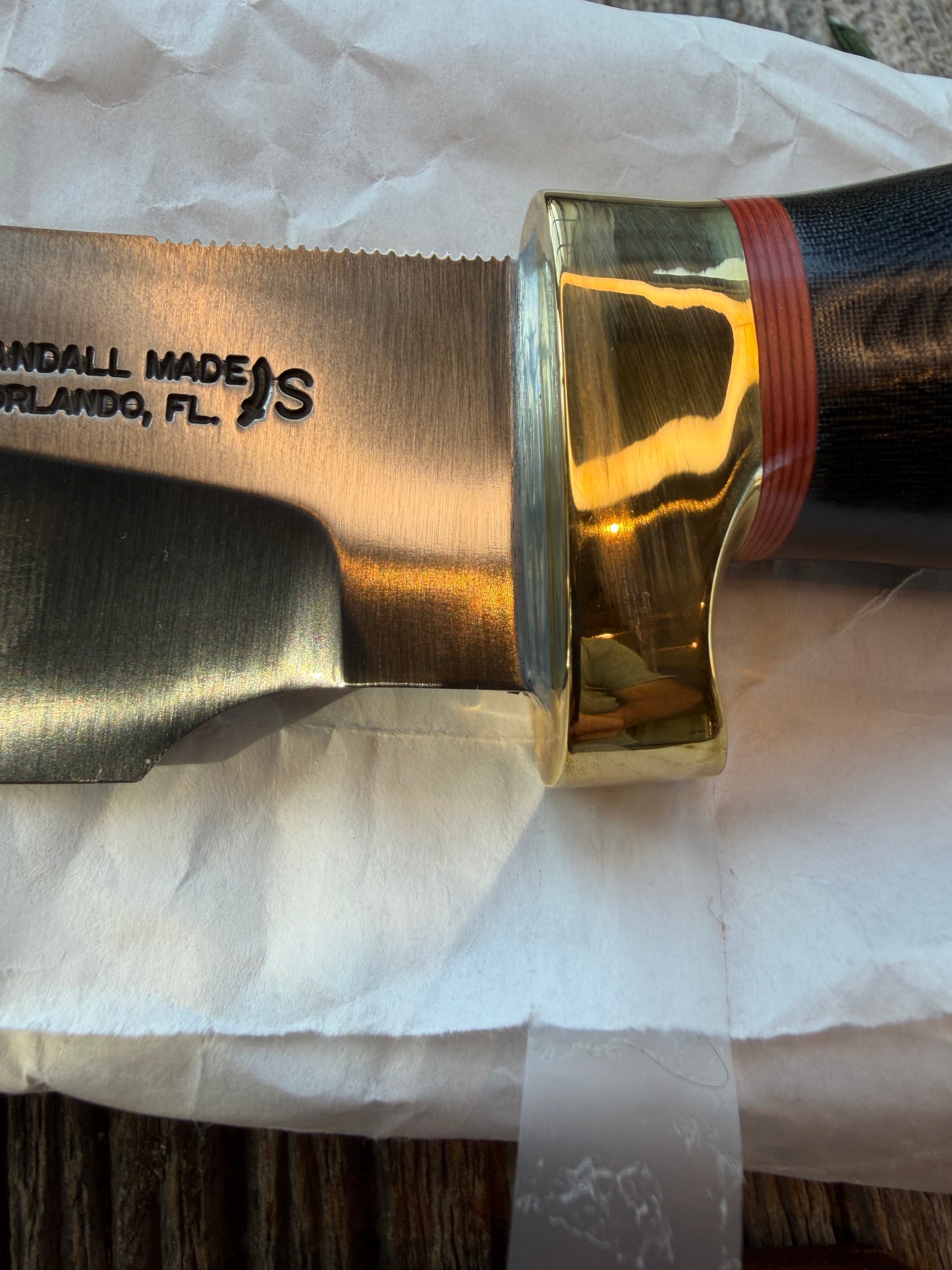 New in Paper Randall Chef’s Knife. Black Micarta in Brass with red spacers. Natural end, stainless steel blade and a lanyard.