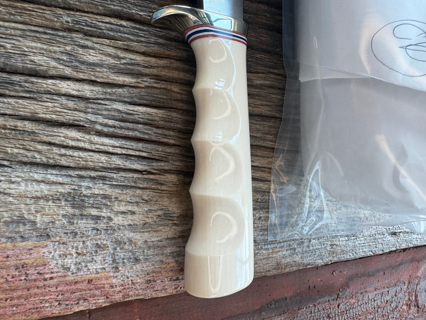 Randall Model Combat Companion with a nice piece of customer supplied Warthers Resin with finger grooves. Teeth, Stainless Steel, Nickel Silver Hilt and a raw natural end.