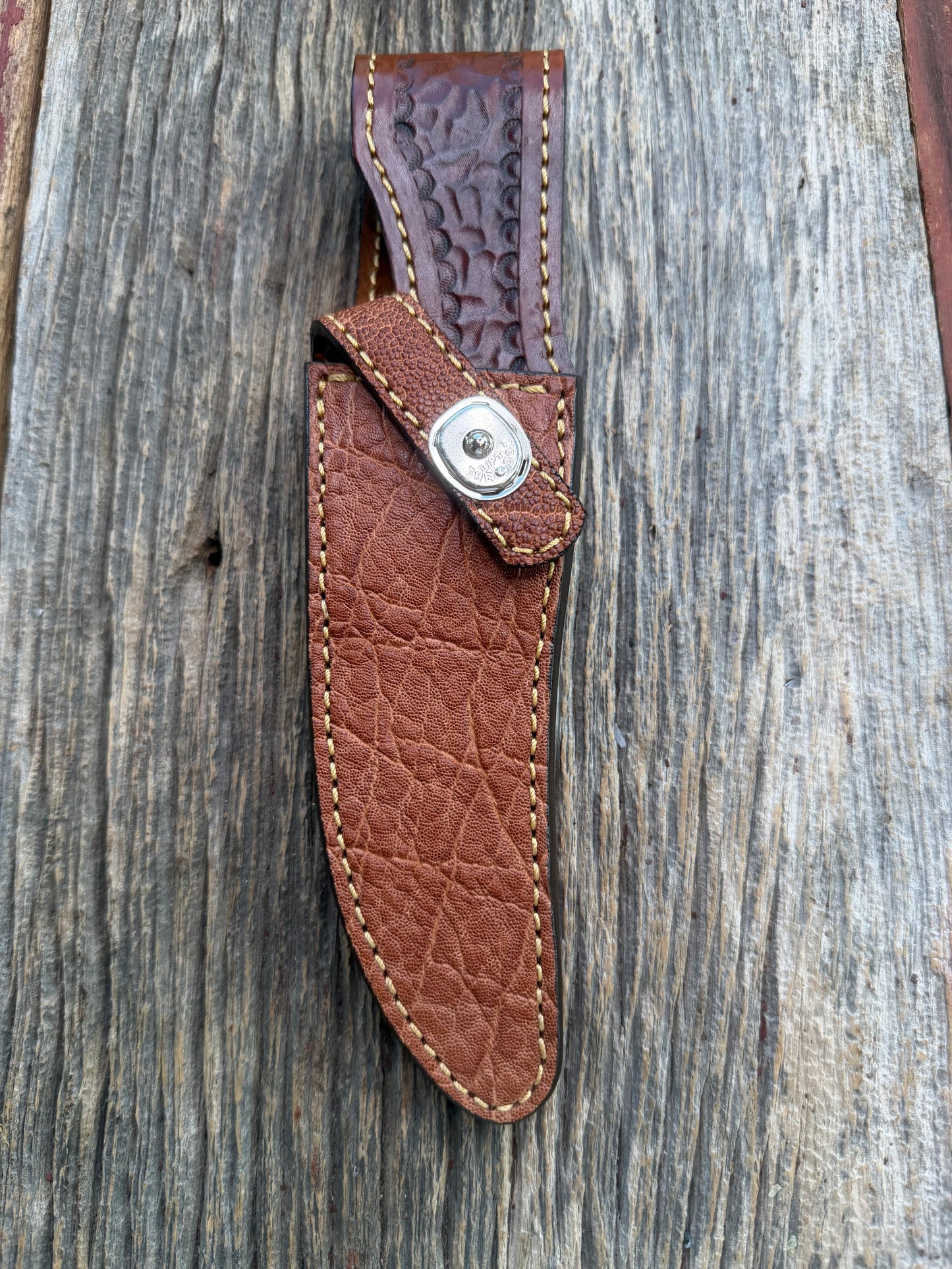 New Randall Model 27 Sheath in Exotic thick and textured Rust colored Elephant hide on brown leather from Treeman with a silver Canteen snap. Hand tooled belt loop. Killer sheath.