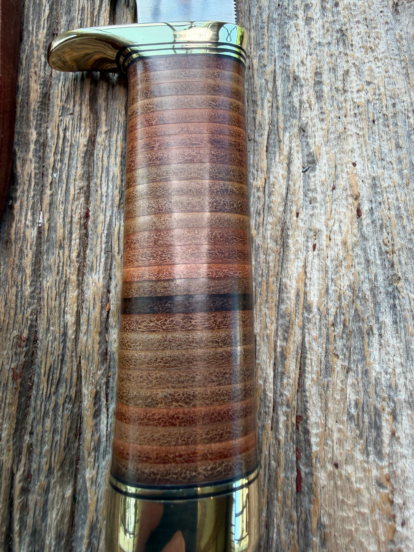 New Randall Model 19-5 Bushmaster with a Leather handle. Carbon blade, Brass single hilt. Brown leather sheath.