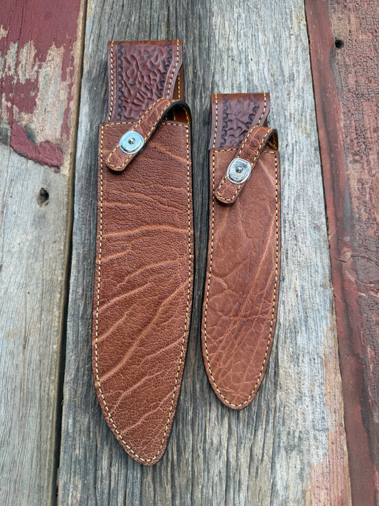 New Randall Model 12-11 Large Sasquatch and 12-8 Small Sasquatch Sheaths in Exotic thick and textured Rust colored Elephant hide on brown leather from Treeman with silver Canteen snaps. Hand tooled belt loop. Killer sheath. Selling as a pair…