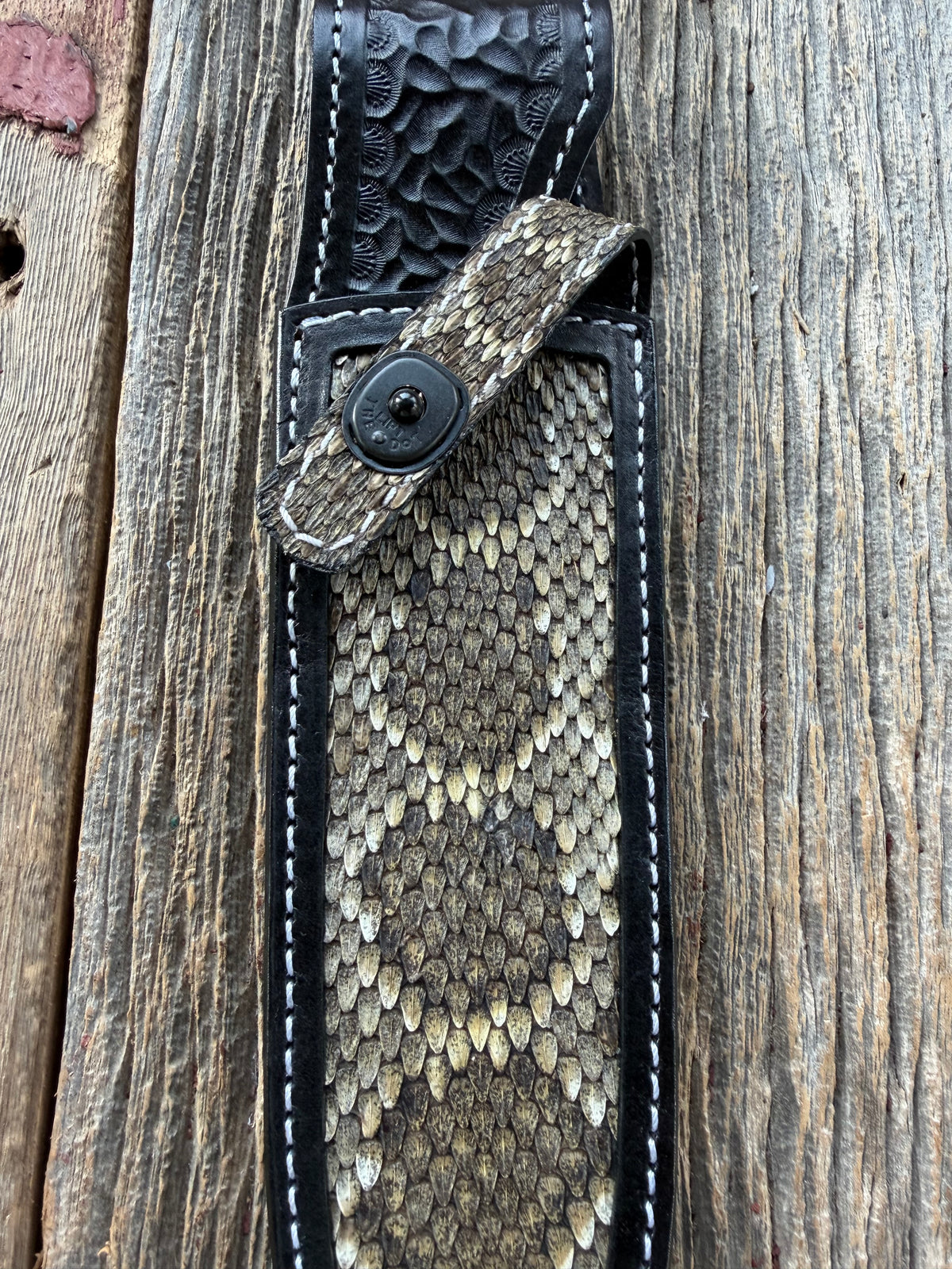 Randall Model Clinton Special sheath with inlayed Western Diamondback RattleSnake skin from Treeman Sheaths. Very dark skin on brown leather, white deviated stitching and black canteen snaps.