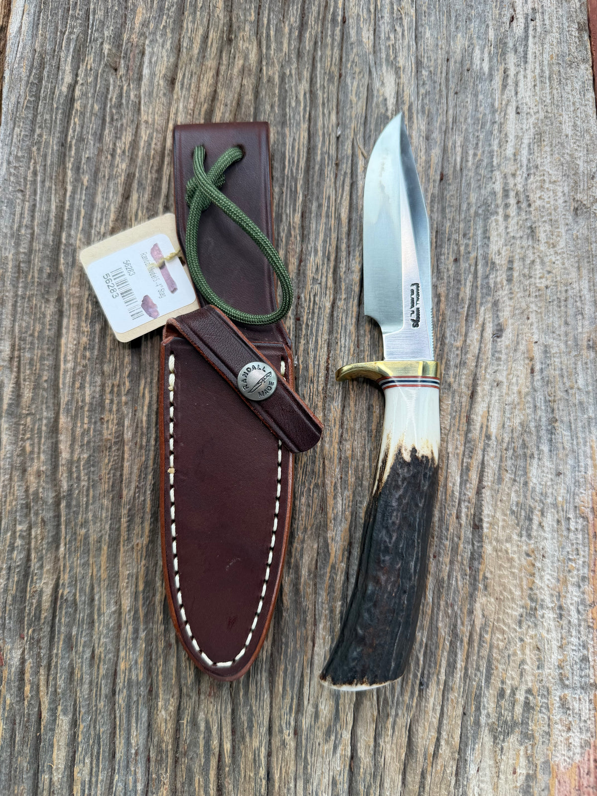 New Randall Model 5-4 with a Stag handle. Stainless steel blade, brass single hilt and natural butt. Red white and Blue spacers.